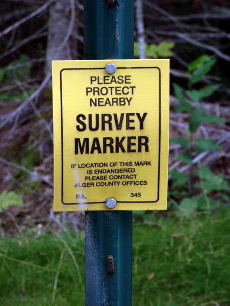 Sign near the new bridge. I didn't know that survey
		  markers were an endagered species.