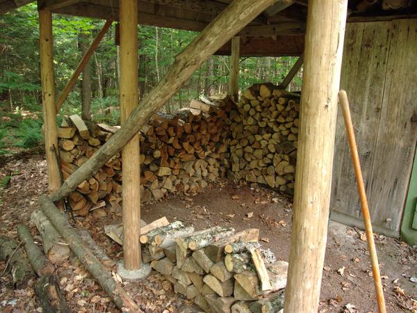 Woodshed prior to restacking wood.