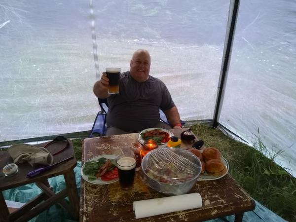 Jon with a burger dinner in the canopy.