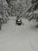 Matt riding into the cabin on the snowmobile he rented.