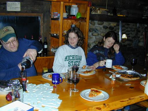 Jon, Amelia, and Vittoria taking a break from dominoes to eat.