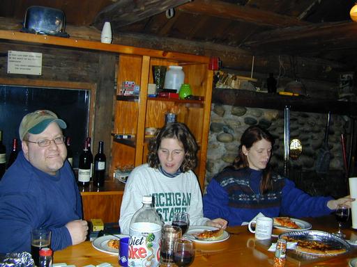 Jon, Amelia, and Vittoria taking a break from dominoes to eat.