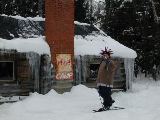 Jon snowshoeing past the cabin.