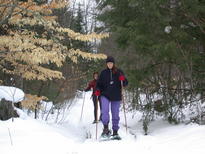 Vittoria and Amelia snow shoeing out from the cabin.