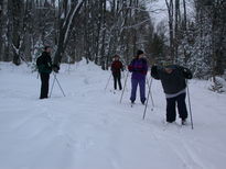 Bill, Amelia, Vittoria, and Jon crosscountry skiing near the Lucky Buck.