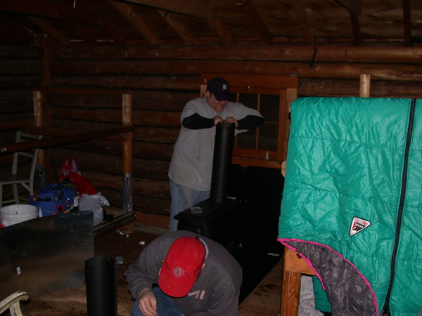 Bill and Jon installing the new wood stove.