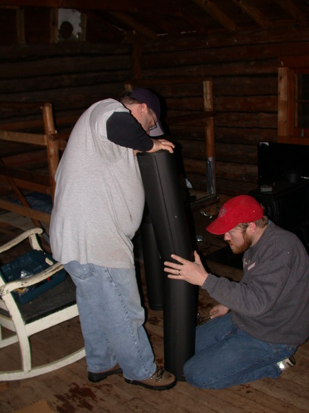 Bill and Jon installing the new wood stove.