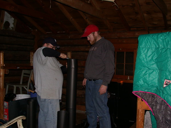 Bill and Jon installing the new wood stove.