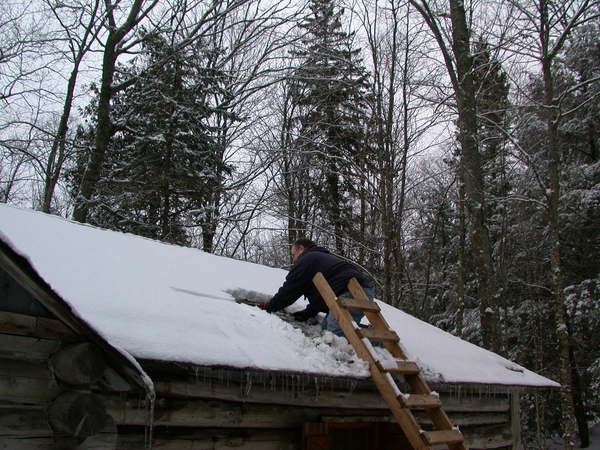 Jon installing the chimney for the new stove.