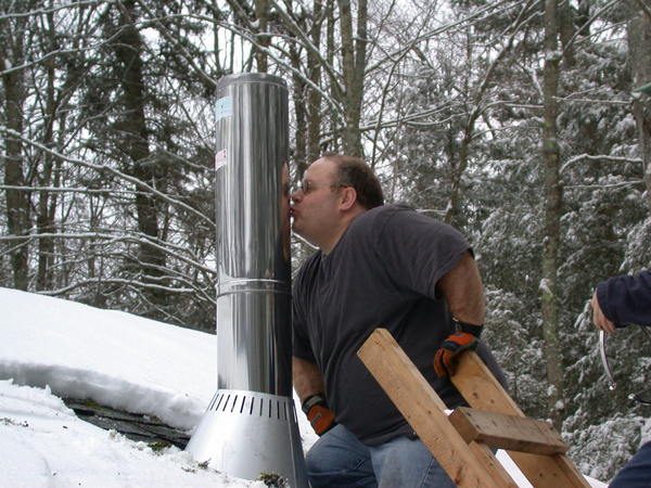 Jon "christening" the chimney for the new
		  stove.