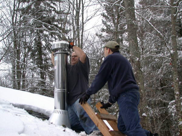 Jon and I putting on the final touches for the new
		  chimney.