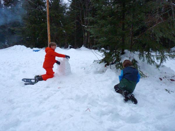 Frankie and Teddy building a snow wall.