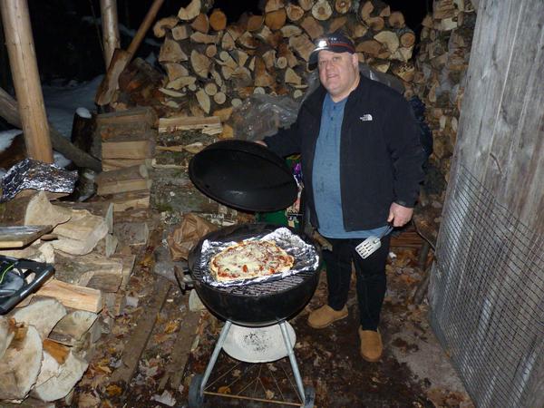 Jon cooking pizza on the grill.