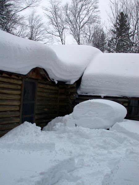 Back of Cabin with snow on the picnic table.