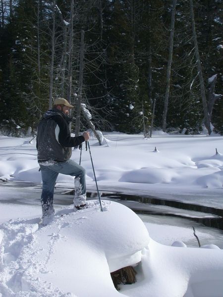 Bill on snowshoes overlooking the river behind the cabin.