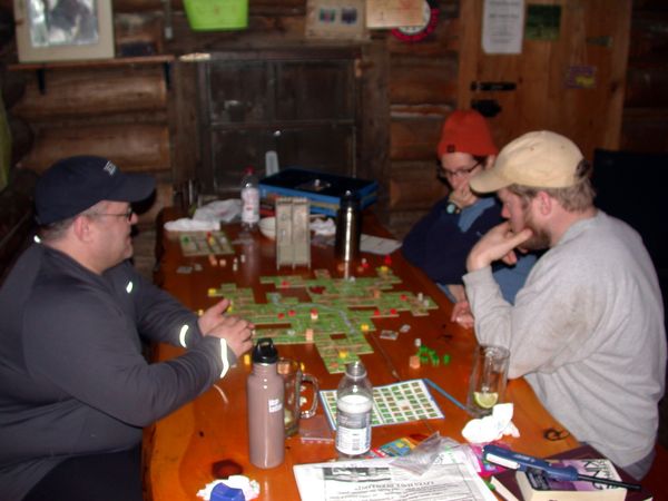 Jon, Bill, and Amelia studying the Carcassonne game (played with all the expansion sets we have).