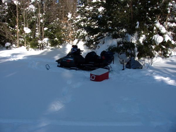 Snowmobile and some gear at the driveway into the Cabin.