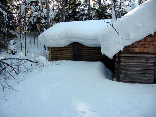 Bunk room door buried in snow.