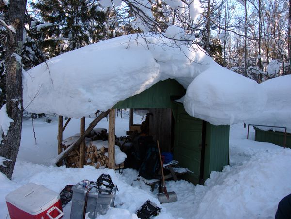 Wood shed with gear strewn about.