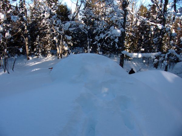 Chimney for the large wood stove buried under a lot of snow.