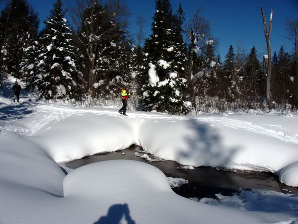 Doug skiing across the buried beaver dam.