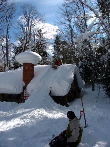 Jon pushing Paul down the toboggan run from the roof of the Cabin.