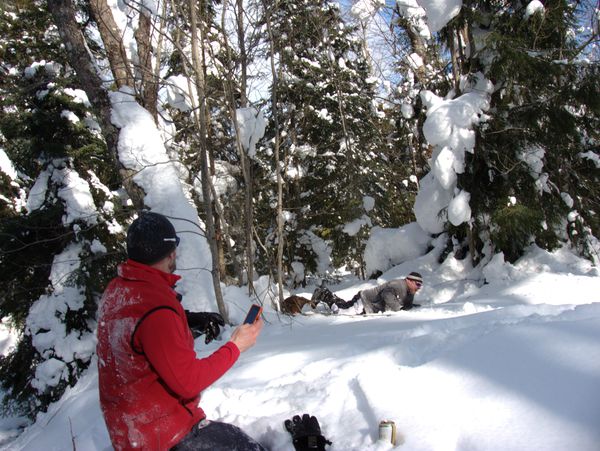 Jon laughing hysterically after hitting the trees at the
             end of his toboggan run.