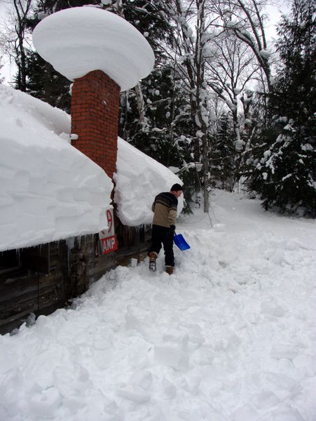 Bill clearing snow from around the Cabin walls.