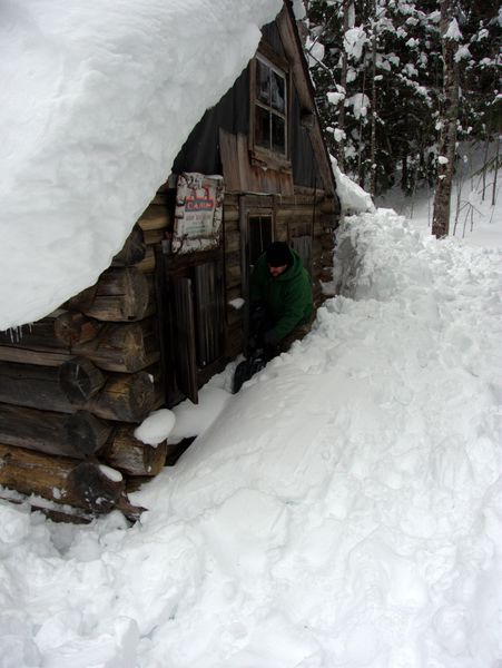 Paul clearning snow from along the Cabin walls.