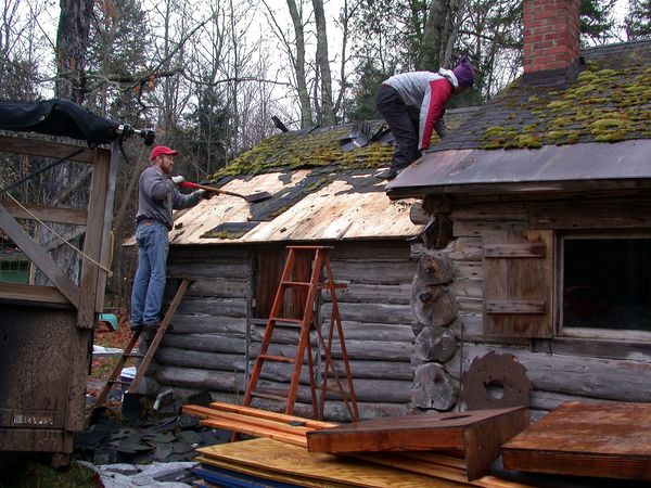 Removing shingles from the kitchen roof.