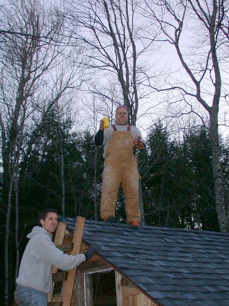 Jon with two beers on the completed cabin roof.