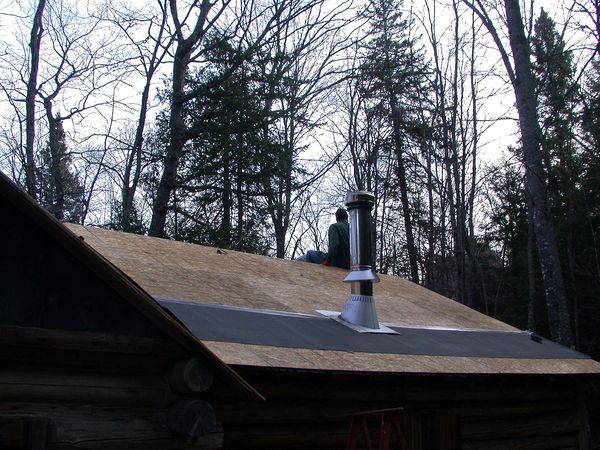 Bunk room roof sheathed and ice guard in place.