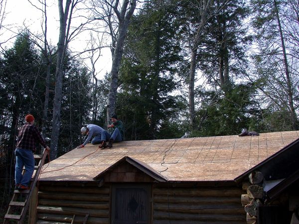 Cutting the edge off the sheathing on the bunk room.