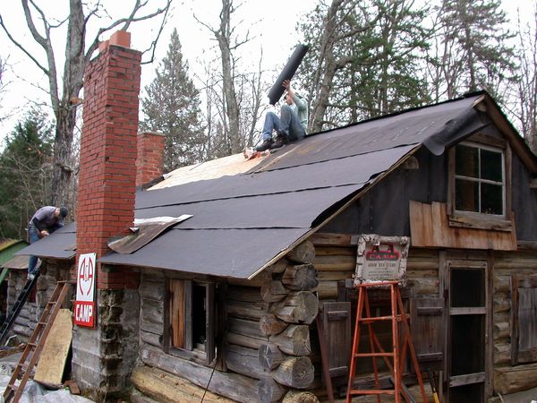 Finishing the tar paper on the roof.