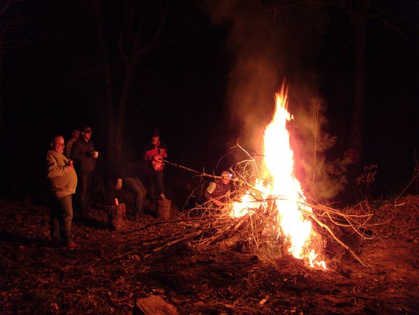 Standing around the burning stump.