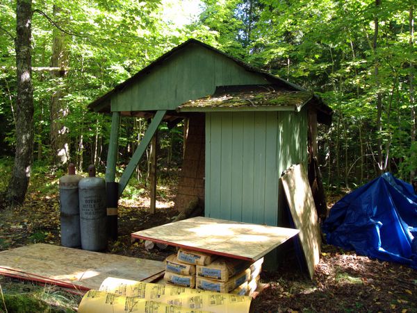 Front of wood shed with repair supplies.