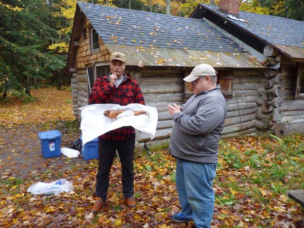 Doug with smoked fish, Jon on his phone.