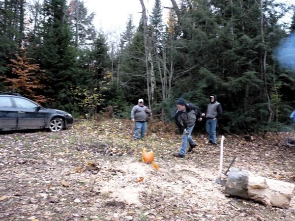 Action shot of Bill slicing a pumpkin with a machete.