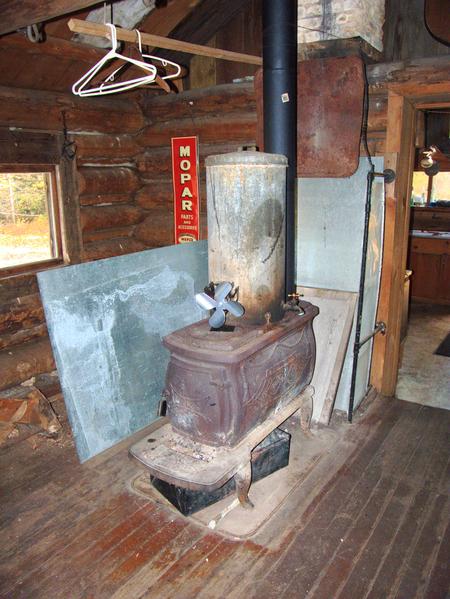 New, heat powered fan (that is actually spinning!) on the old wood stove with the old water tank radiator.