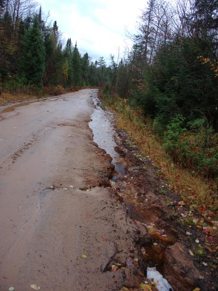 Water doing its work eroding a channel along McCloud Grade.