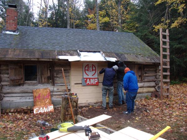 Sign remounted and final sealing being put in place.