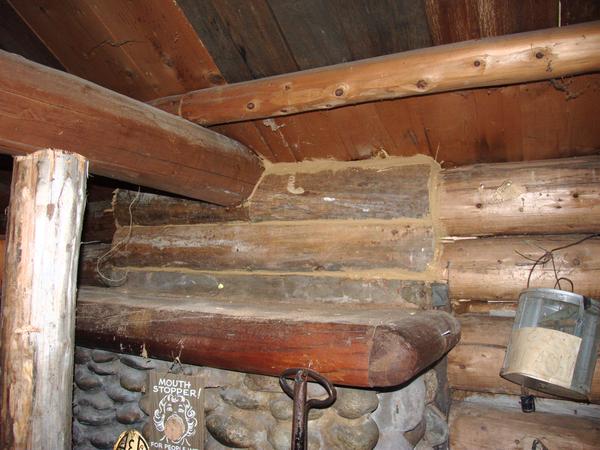 New logs above the fireplace replacing the waterlogged, rotten ones.