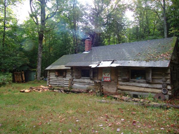 The Cabin with smoke coming from the wood stove.
