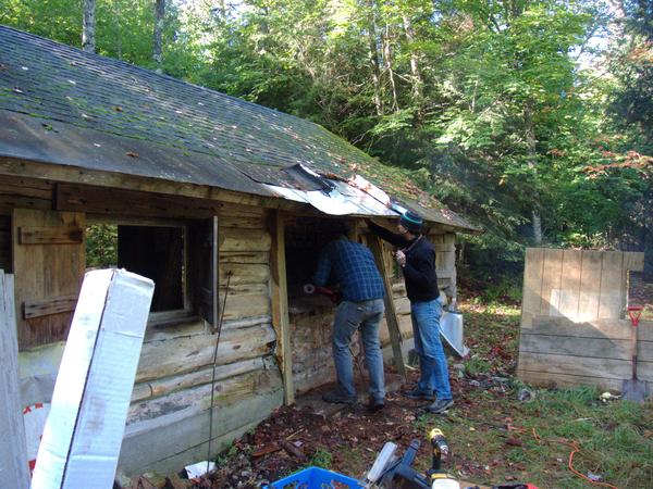 Angle grinder cutting out part of the old fireplace.