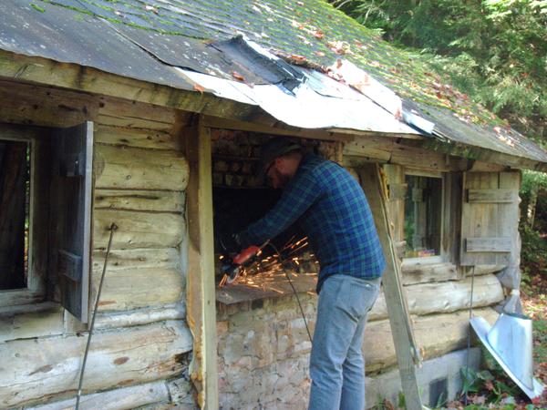 Andy using the angle grinder cutting out part of the old fireplace.