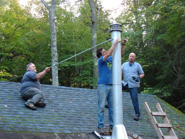 Mikey, Jon, and Jim securing the supports for the new smoke stack.