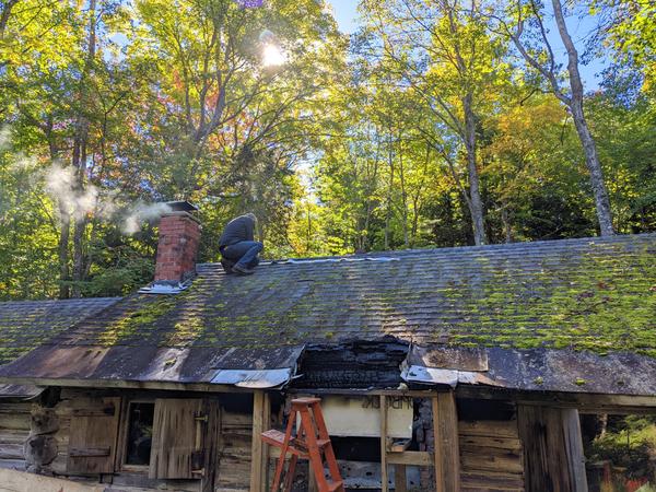 Bill putting zinc strips on the roof.