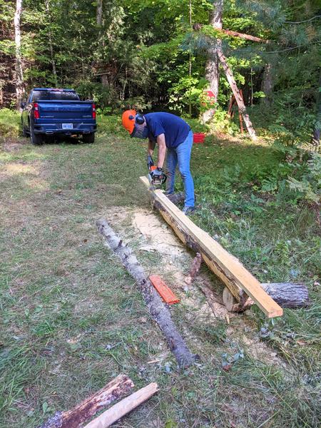 Mikey making a 4x4 post from a log.