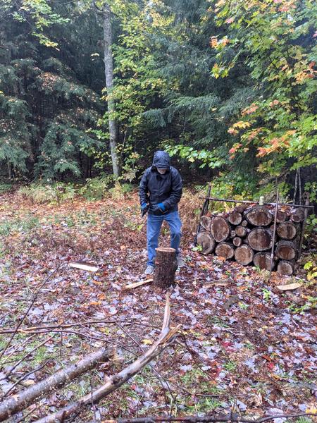 Arthur splitting wood from the downed tree limb.