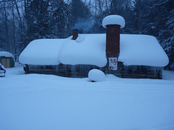 The Cabin the next morning after raining, the temperature dropping, and heat from inside melting snow.